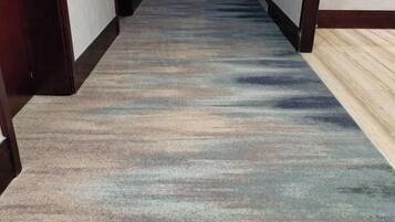 A carpeted hallway with a patterned design.