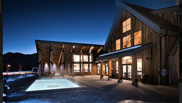 A wooden building with large windows and a covered outdoor area with a pool. - Pristine Home Near Sun Valley (Hailey)