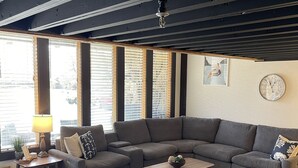 A modern living room with a sectional sofa, a coffee table, and a rug. - Golf Getaway with Golf Cart on Grand Lake in Shangri-La (Afton)