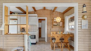 A cozy cabin interior with a kitchen, dining area, and a wooden ceiling. - 2 bedroom awesome home in Faaborg (Faaborg)