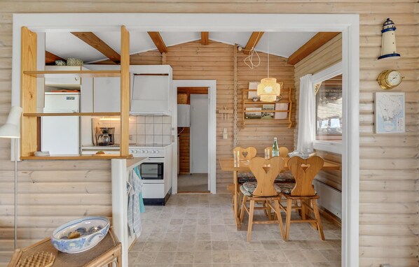 A cozy cabin interior with a kitchen, dining area, and a wooden ceiling. - 2 bedroom awesome home in Faaborg (Faaborg)