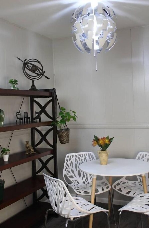 Cozy retreat with a round table, comfortable chairs, and a bookshelf.