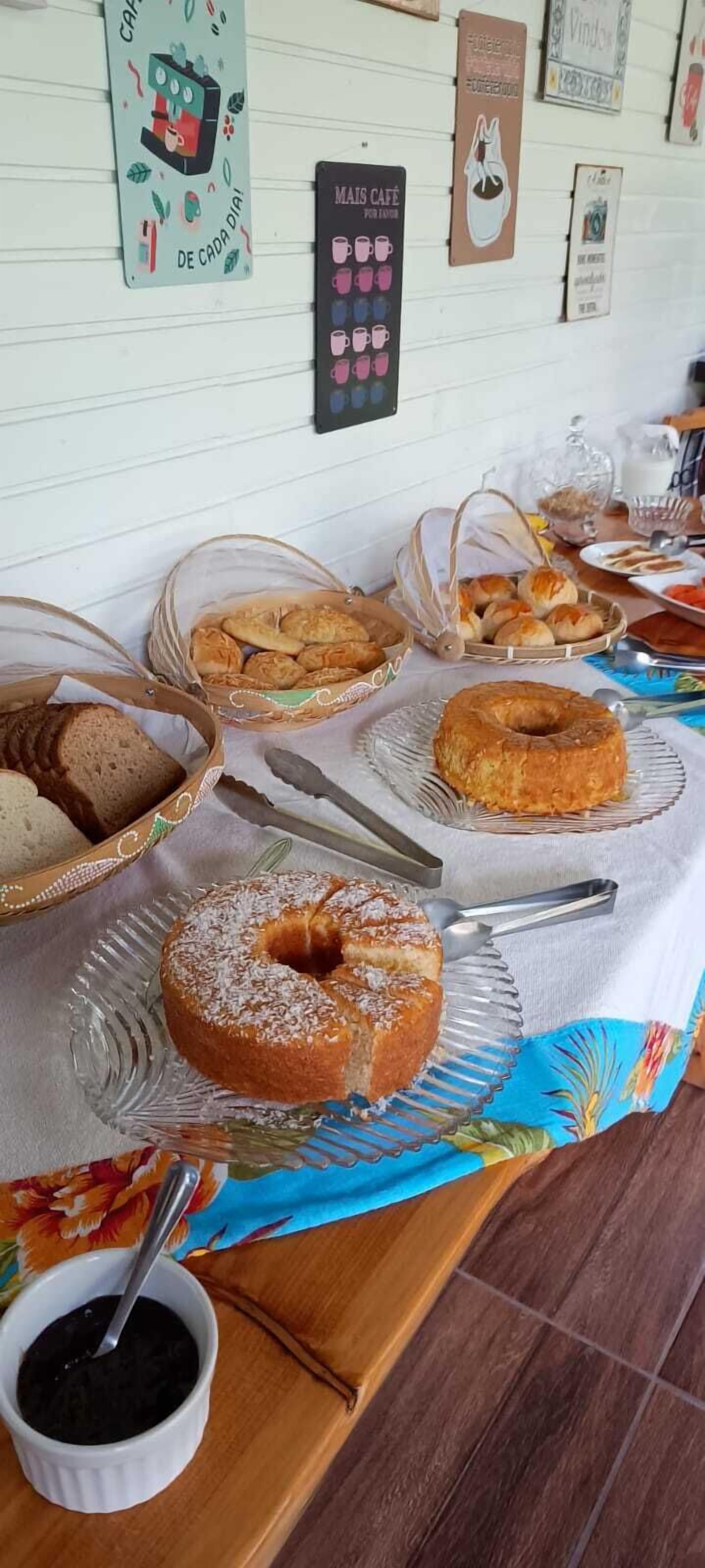 A buffet table with various baked goods and a sign indicating 'MAIS CAFE'.