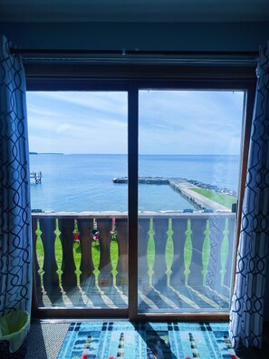 Enjoy breathtaking views of the calm body of water and distant shoreline from the balcony.