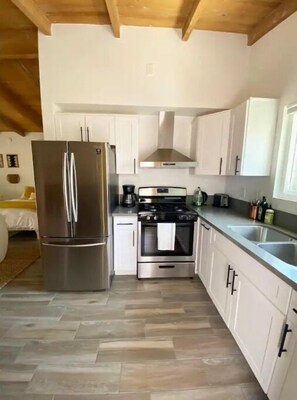 Enjoy cooking in this well-equipped kitchen with a refrigerator, oven, and gas stove.