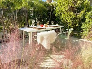 Enjoy a serene meal amidst lush greenery and an outdoor setting.