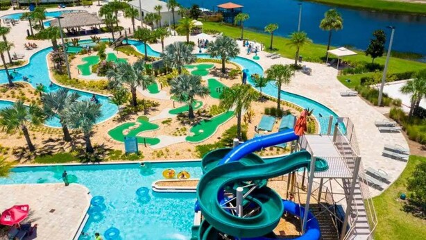 A water park with a large pool, slides, and a golf course. - Stylish Family Home | Private Pool | 111 (Kissimmee)
