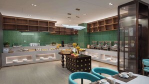 A modern restaurant with a central island, seating area, and green-tiled walls. - Microtel by Wyndham Changsha Yuhua (Changsha)