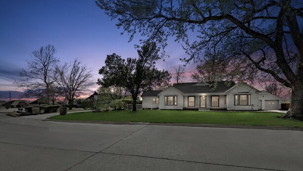 A two-story house with a front lawn, a driveway, and a street view. - Home adjacent to Country Club, near Hospitals, Park, College and shopping. (Ada)