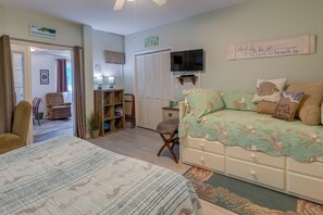 A bedroom with a bed, a desk, a chair, and a TV. - Sneads Ferry Vacation Rental Studio w/ Water Views (Sneads Ferry)