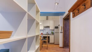 A kitchen with white cabinets, a microwave, and a refrigerator. - GuestHost - Ferrara Station Essential Apartment w/parking (Ferrara)