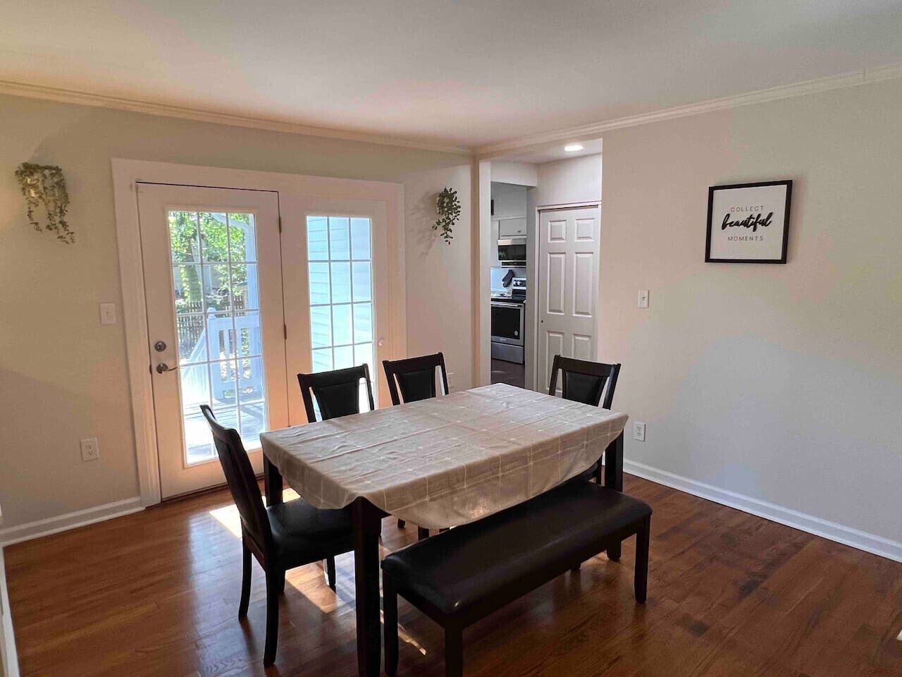 A dining area with a table, chairs, and a bench.