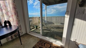 A room with a view of a wooden deck and a balcony. - Lakefront Apt. 4 on 2nd Floor Near Wineries, Marina, & Geneva-On-The-Lake (GOTL) (Geneva)