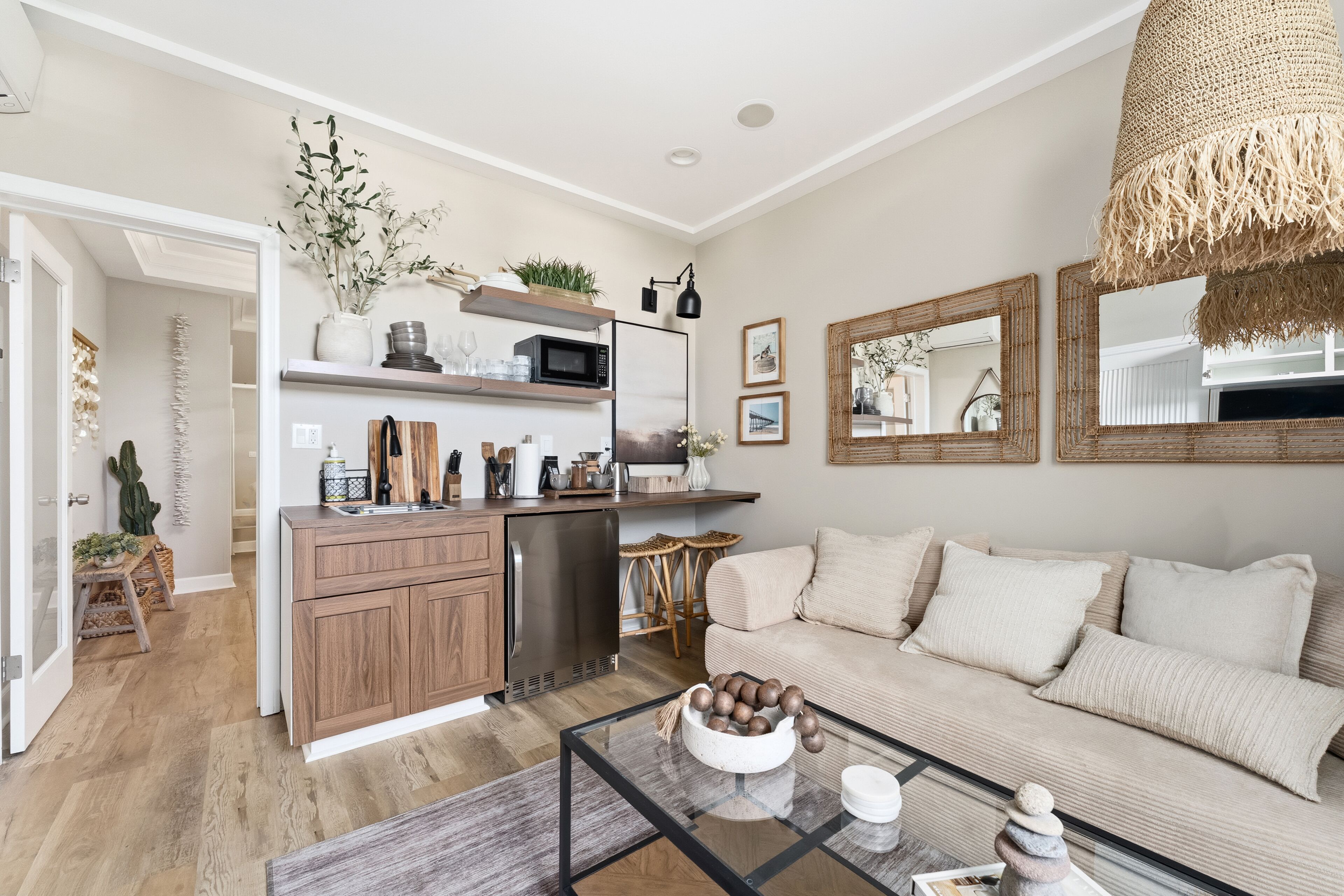 A modern kitchen with wooden cabinets, a built-in microwave, and a dining area with a glass table.