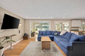 Relax in this serene space with a large sofa, flat-screen TV, and a balcony overlooking the lake.