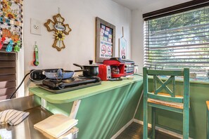 A kitchen with a stove, a red coffee maker, and a window with blinds. - Near Lakes & Parks: Lady Lake Farm Getaway (Lady Lake)