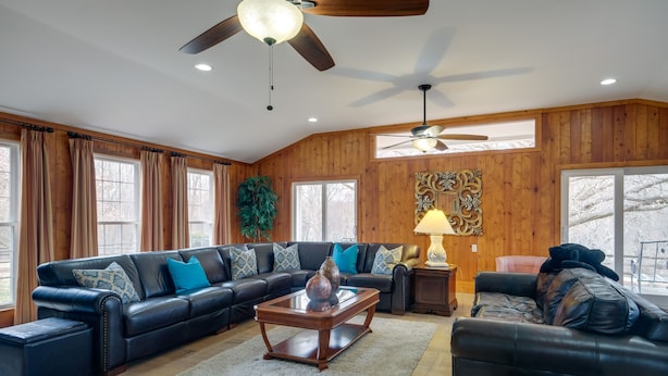 A spacious living room with a large sectional sofa, a coffee table, and a ceiling fan. - Nature Getaway w/ On-Site Trails, 17 Mi to DC! (Brookeville)