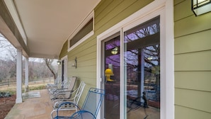A covered porch with several chairs and a sliding glass door leading to an outdoor area. - Nature Getaway w/ On-Site Trails, 17 Mi to DC! (Brookeville)