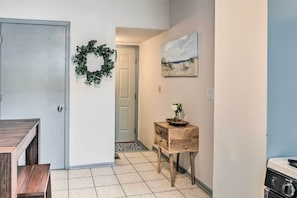 Stylish hallway with a bench, side table, and beautiful artwork.