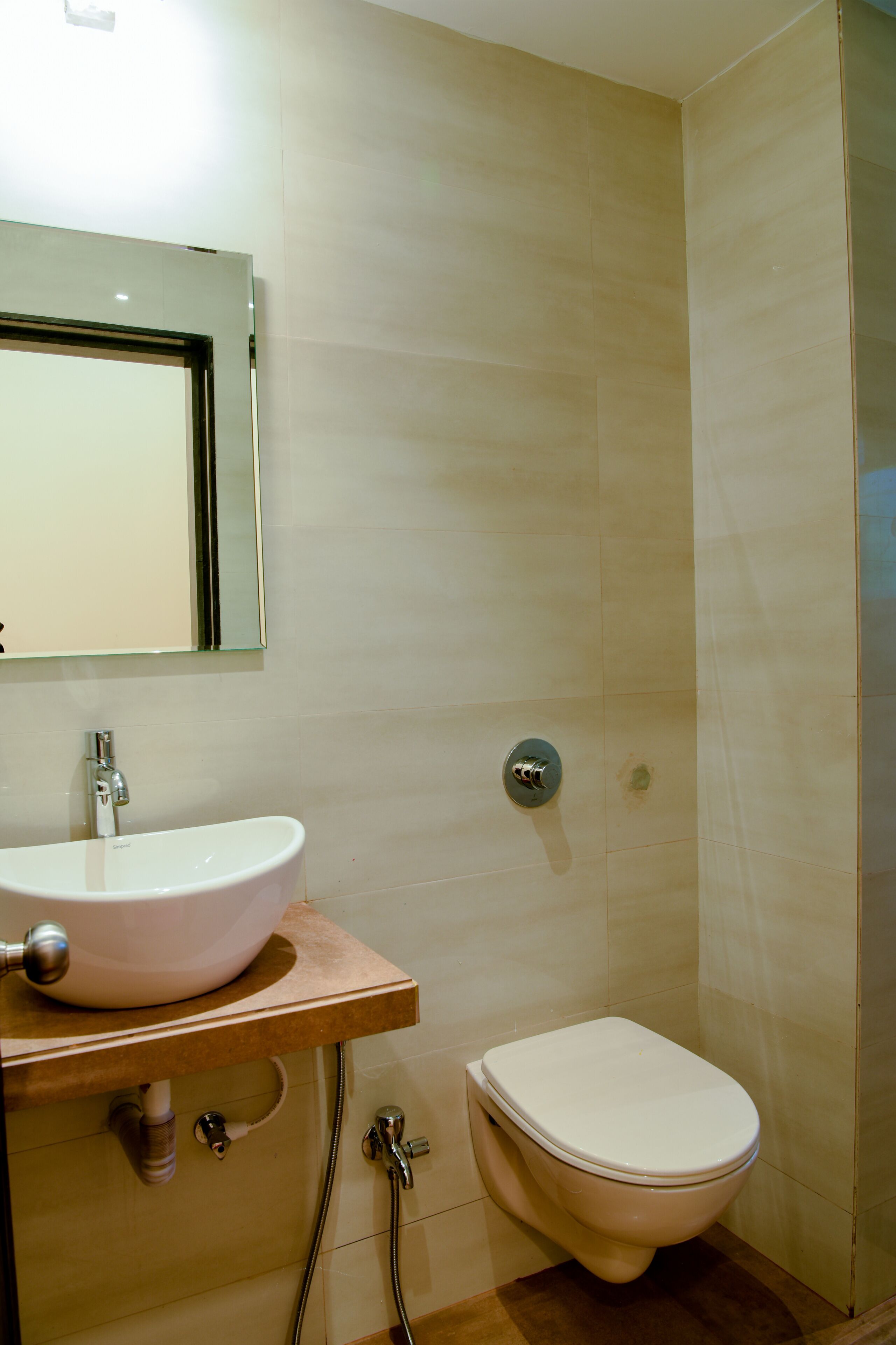 A bathroom with a sink, mirror, and toilet.