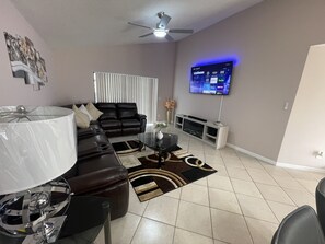 Relax in this stylish living room with a sofa, coffee table, and flat-screen TV.