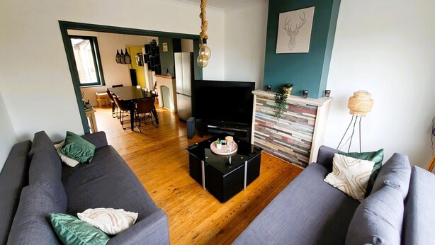 A modern living room with a sofa set, a coffee table, and a flat-screen TV. - Holiday home in Zuienkerke with a terrace (Zuienkerke)
