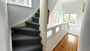 A staircase with a white railing and a window at the top. - Holiday home in Zuienkerke with a terrace (Zuienkerke)