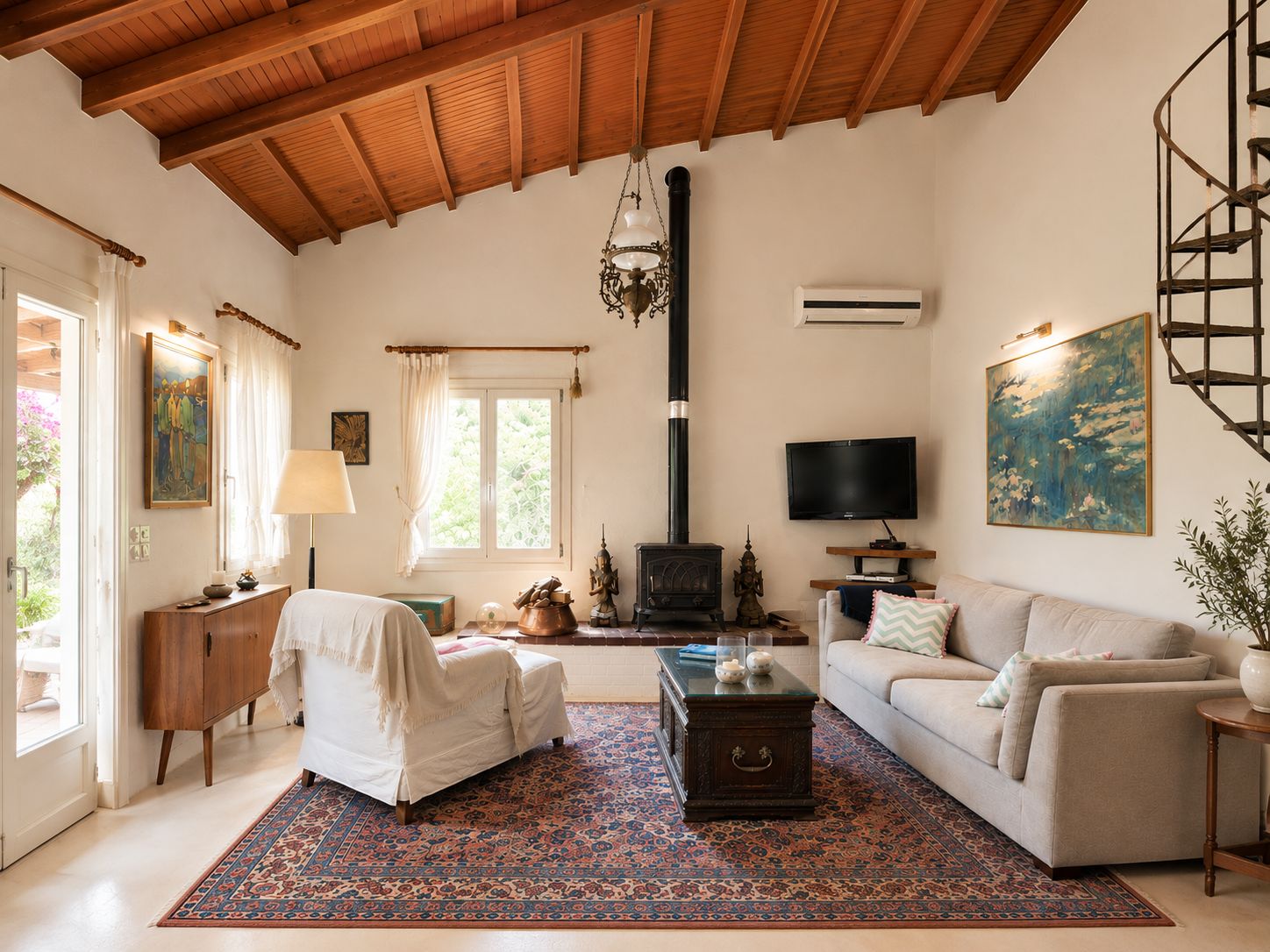 A living room with a fireplace, sofa, TV, and a large window.