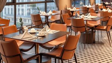 A restaurant with tables set for dining, chairs, and a checkered floor.