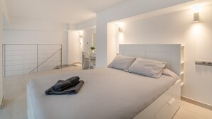 A modern bedroom with a large bed, bedside tables, and a desk with a chair. - Holiday Apartment "Alison's Loft" with A/C & Wi-Fi (Alicante)