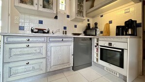 A kitchen with white cabinetry, a Bosch oven, a dishwasher, and a coffee maker. - House for 4 with Wifi near the beach in Dolus-d'Oléron (Dolus-d'Oléron)