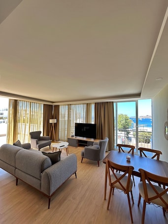 Senior Suite | Living area | 80-inch plasma TV with satellite channels, TV