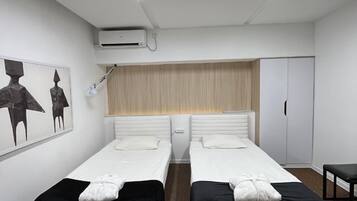 Classic Twin Room | Blackout drapes, iron/ironing board, free WiFi, bed sheets