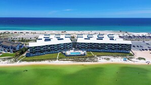 A modern hotel with a pool, located near a beach and the ocean. - Escape to paradise at Palm Beach Club #217/Sound Front Condo! (Pensacola Beach)