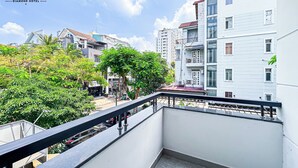 A balcony with a view of a cityscape, including a hotel named "Lucky Star" and other buildings. - Golden Sun Hotel Apartments (Ho Chi Minh City)