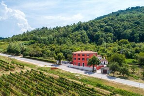 Situated on a hillside, this standalone building offers a secluded retreat amidst a well-maintained landscape.