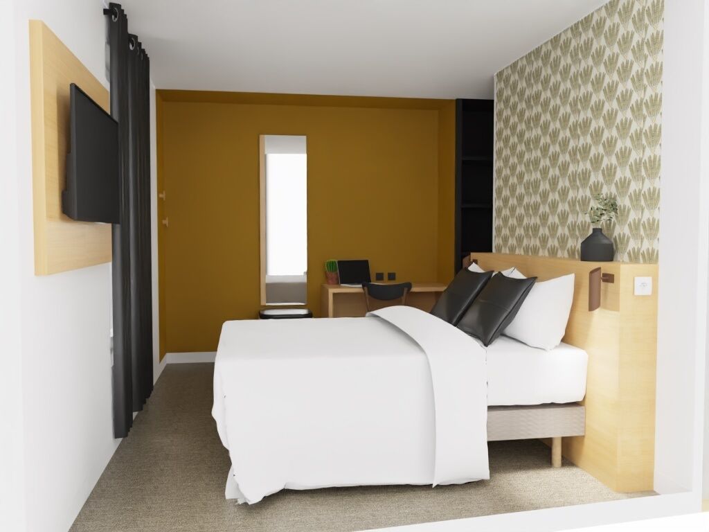 Ein modernes Hotelzimmer mit Bett, Schreibtisch und Fernseher.