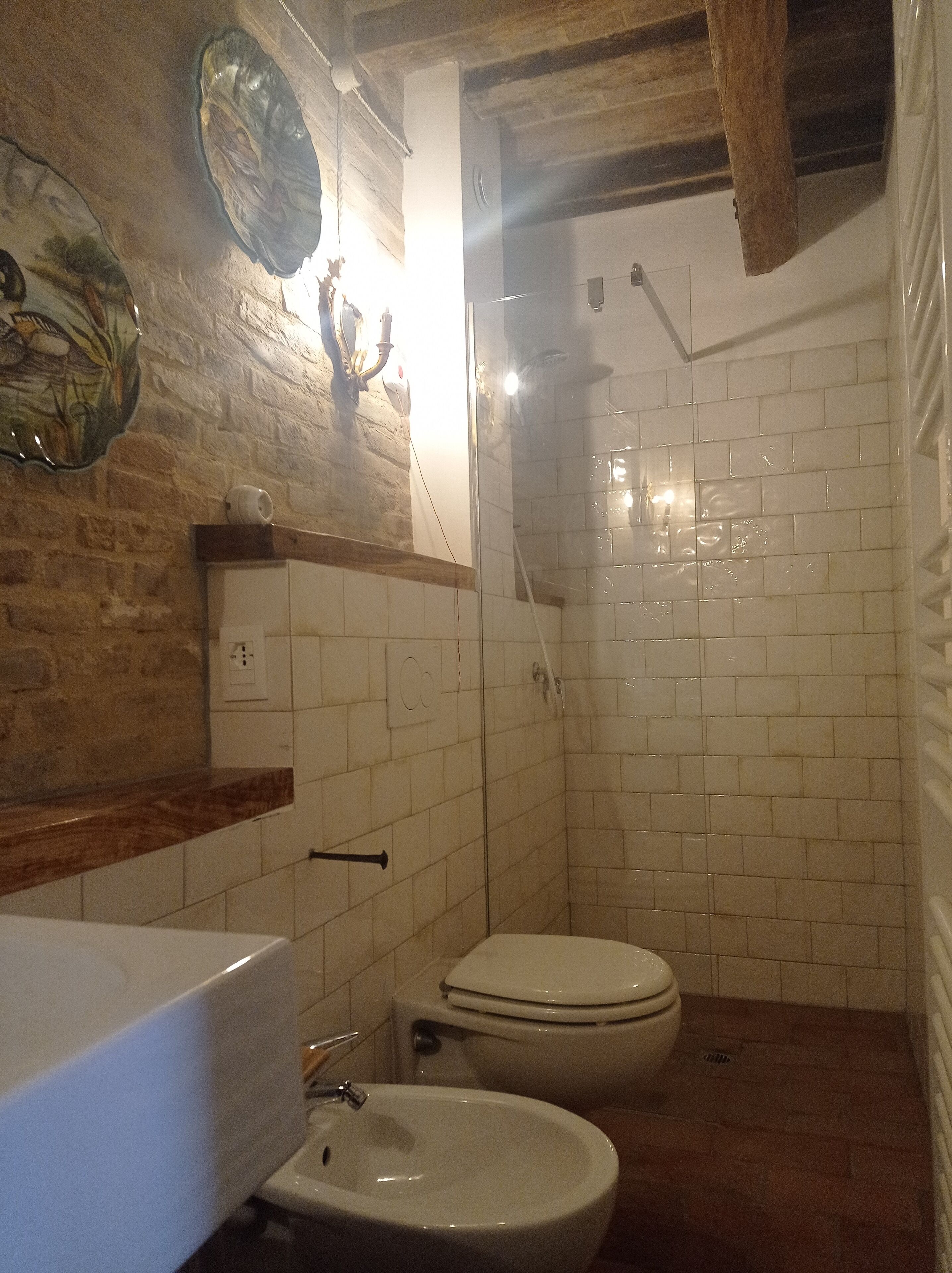 A bathroom with a sink, bidet, and toilet.