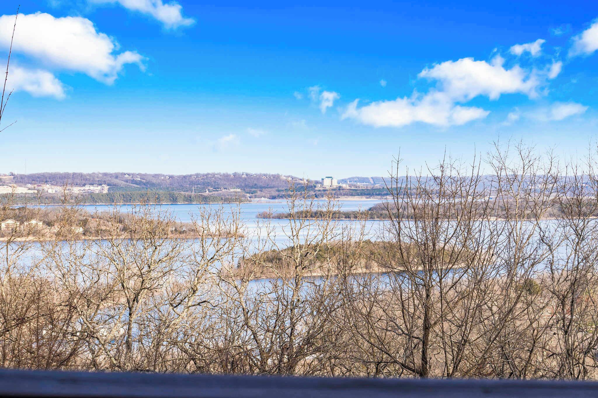 A river landscape with a bridge in the distance.