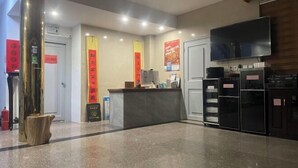 A reception area with a reception desk, a television, and a fire extinguisher. - Yandang Mountain Xiufeng Tower (Yueqing)