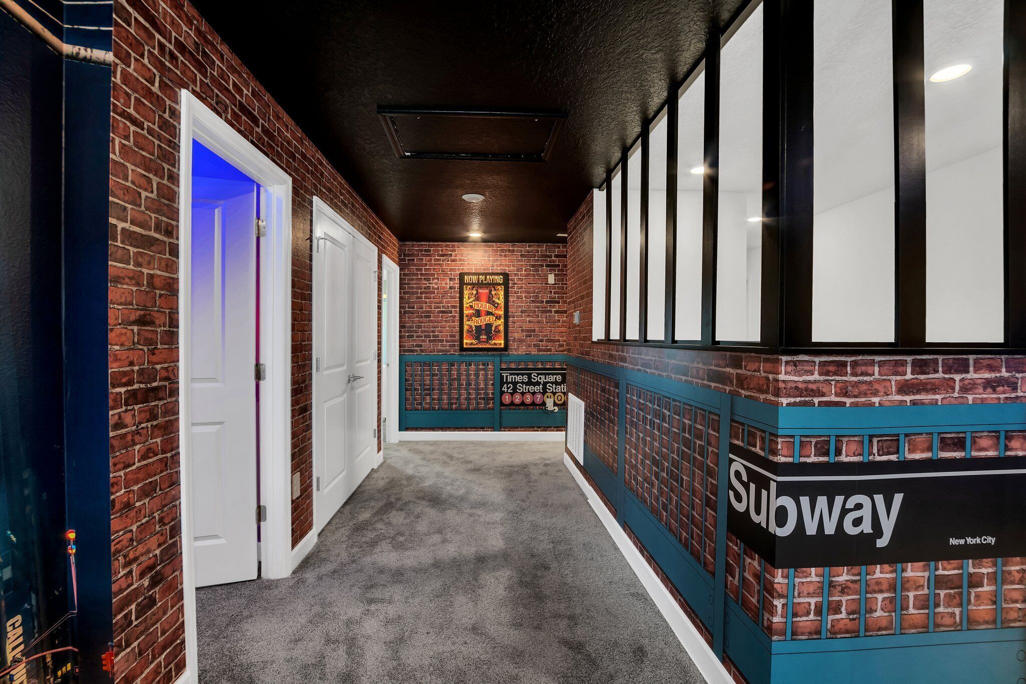 A hallway with brick walls, a Subway sign, and a poster on the wall.