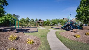 A park with a playground, a picnic area, and a walking path.