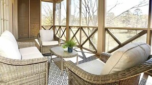 A covered porch with wicker furniture, a ceiling fan, and a view of trees. - The Sadie, 3BR Townhome by VelvetDitchVillas (Oxford)