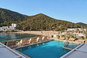 Seasonal outdoor pool, open 10:00 AM to 8:00 PM, pool umbrellas