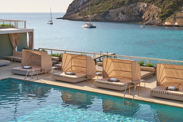 Seasonal outdoor pool, open 10:00 AM to 8:00 PM, pool umbrellas