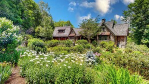 A traditional stone house with a garden in front.