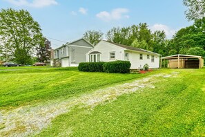 A two-story house with a well-maintained lawn and a covered porch.