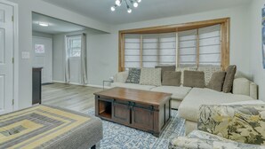 A living room with a sofa, a coffee table, and a patterned rug. - Walkable to RIT/Comfortable Stay near university (Rochester)