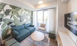 Deluxe Apartment | Living area | 55-inch Smart TV with digital channels, TV, streaming services - The Laundry Rooms Station Park Kitchener (Kitchener)