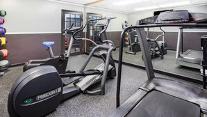A gym with treadmills, elliptical machines, and a mirrored wall. - Travelodge by Wyndham Livonia/Canton/Novi Detroit Area (Livonia)